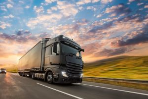 Truck with container on highway, cargo transportation concept. Shaving effect.